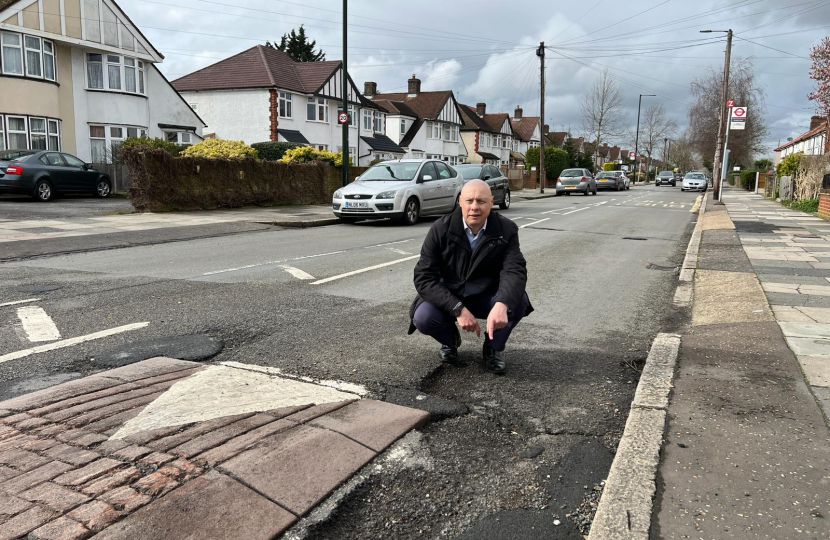 Jonathan Hulley by dangerous pothole on Powder Mill Lane in Whitton