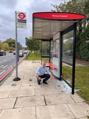 Jonathan Hulley next to vandalised bus stop on the Chertsey Road